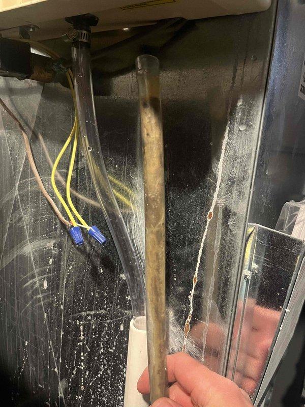 Responded to humidifier leak complaint and performed system inspection. Upon arrival, examined outdoor HVAC unit and accessed internal components to diagnose the issue. Inspected humidifier sight glass, which revealed discolored, murky water indicating contamination and potential mineral buildup in the system. The condition of the fluid confirmed active leaking concerns and need for humidifier maintenance. Documented equipment condition with photos showing exterior unit with protective guard and internal components including wiring and fluid levels. Due to scheduling constraints, AC tune-up was deferred and will require separate appointment.