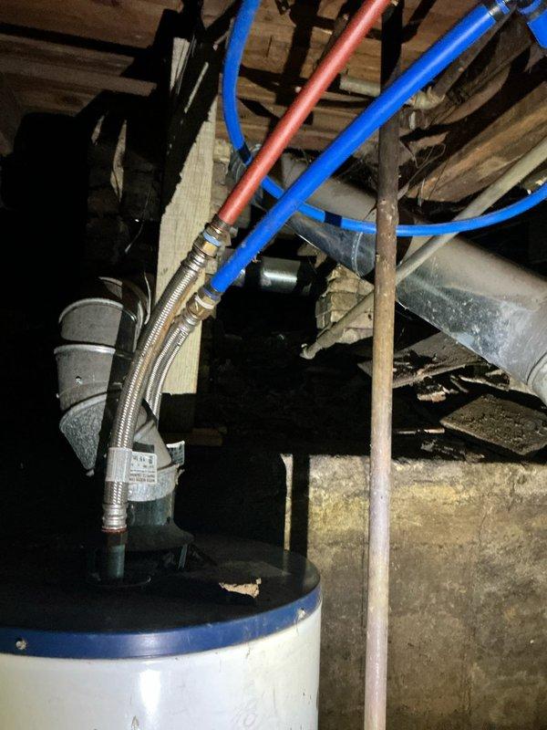 Responded to flooded basement emergency requiring assessment and estimate for complete HVAC and water heater replacement. Documented existing Goodman furnace unit, water heater, and associated mechanical systems that sustained water damage from submersion. Photographed damaged equipment including furnace with exposed ductwork, PVC venting, electrical connections, and water heater with PEX plumbing configuration to support replacement estimate for insurance purposes.