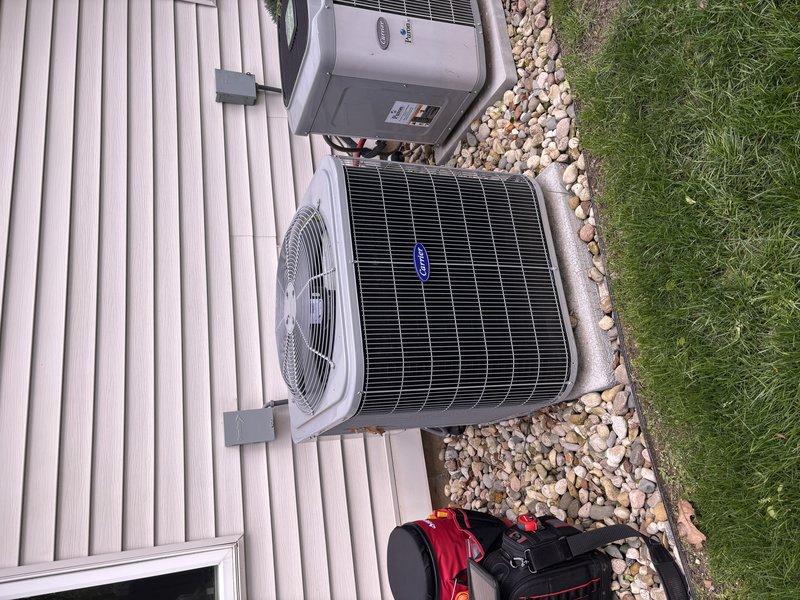 Completed annual heating and cooling maintenance visit on residential HVAC system. Performed comprehensive tune-up on furnace, humidifier, and Carrier air conditioning condenser unit. Inspected indoor air handler cabinet, ductwork connections, and all associated piping systems including copper and PVC lines. Verified proper operation of water heater connections and safety controls. Examined outdoor condenser unit including fan operation, coil condition, and electrical disconnect box. All components found to be in good working condition with no issues identified. System operating within normal parameters. Documentation photos captured for service records.