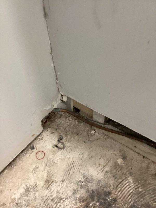 Brazed suction line repair on HVAC system and recharged unit with 2 tons of R22 refrigerant. Wall access was required to complete the repair, with opening created to reach the damaged suction line section for proper brazing and system restoration.