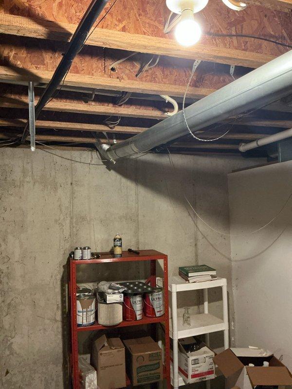 Conducted evening sales estimate for complete furnace and air conditioning system replacement in residential property. Assessed existing HVAC infrastructure in unfinished basement area, including current ductwork configuration with large sheet metal trunk lines and flexible branch ducts supported by metal hangers throughout exposed ceiling joists. Documented existing mechanical systems, storage layout, and structural conditions to determine optimal equipment placement and installation requirements for proposed heating and cooling system upgrade.