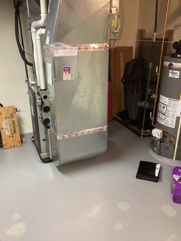 Conducted on-site assessment of 10-year-old Rheem water heater for replacement estimate in residential basement utility room. Documented existing equipment configuration including copper supply piping connections, electrical panel proximity, and clearance requirements around unit. Photographed current installation specifications, manufacturer labels, safety warnings, and surrounding HVAC equipment layout to provide accurate replacement quote for customer-requested water heater upgrade.