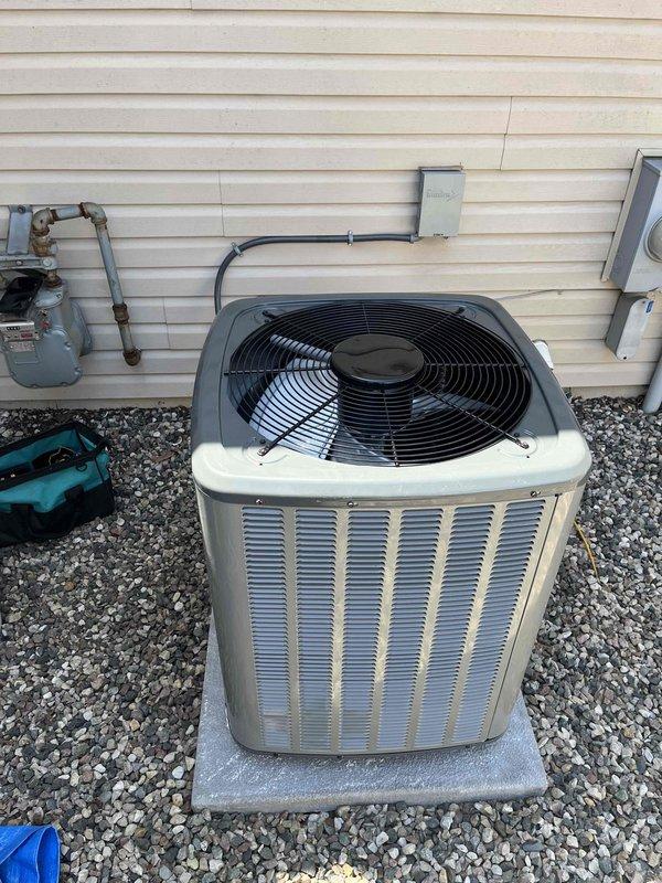 Completed full air conditioning system installation at residential property. Installed two new condenser units on concrete pads in narrow side yard access area between structures, mounted electrical disconnect boxes and conduit on exterior wall, and ran refrigerant lines from outdoor units to interior air handlers. All components properly positioned, secured, and connected per manufacturer specifications with system tested and operational upon completion.