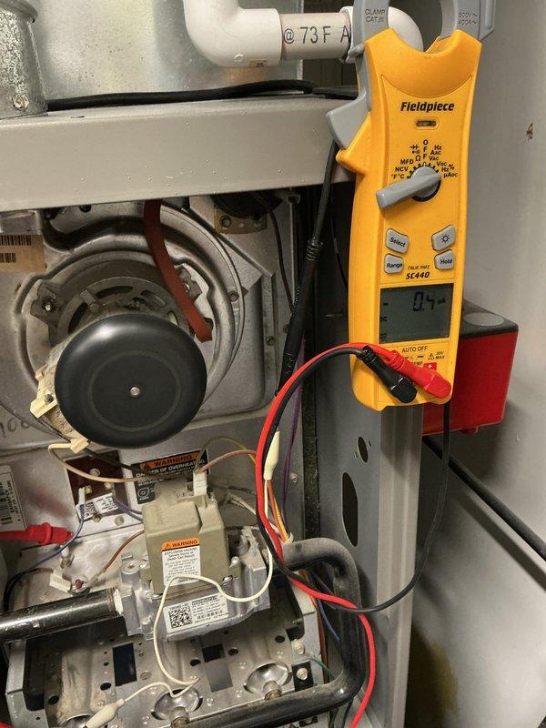 Responded to service call for intermittent igniter failures on 17-year-old furnace that was still providing heat but experiencing reliability issues. Performed diagnostic testing using clamp meter to measure electrical draw and verify igniter circuit performance, inspected control board and gas valve assembly for proper operation, and evaluated overall system condition given age of equipment. Documented findings with photos of internal components and recommended monitoring system performance due to age-related wear on ignition components.
