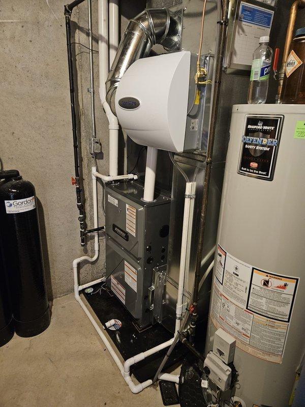 Completed full HVAC system replacement including new furnace and air conditioning condenser unit. Installed furnace in basement utility area with integrated humidifier, connected all ductwork, and ran PVC condensate drainage lines. Mounted outdoor AC condenser on concrete pad, completed refrigerant line connections with proper service valves and caps, verified all electrical connections, and tested system operation for proper heating and cooling functionality.