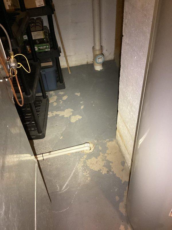 Conducted plumbing project estimate for sewer line issue beneath residence where pipe has developed a belly causing multiple drainage backups. Assessed basement utility area and documented existing conditions including deteriorated Orangeburg piping system requiring replacement to restore proper drainage flow and prevent future sewage backup incidents.