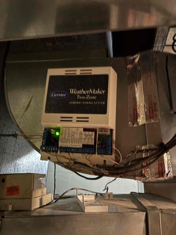 Replaced defective zone control panel on Carrier WeatherMaker two-zone comfort zoning system. Removed old panel, installed new unit, reconnected all zone damper wiring and thermostat connections, and verified proper system operation with all zones responding correctly.