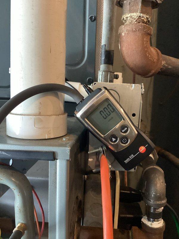 Responded to no heat call where furnace was running but not producing flame. Upon inspection, tested system operation and confirmed unit was cycling but failing to ignite. Performed diagnostic testing with multimeter showing reading of 99.9 ohms, indicating flame sensor was reading out of acceptable range due to carbon buildup and contamination. Removed and cleaned flame sensor rod to restore proper conductivity. Verified ignition sequence, confirmed flame establishment and flame proving circuit functionality. System restored to normal heating operation with proper burner ignition and sustained flame.