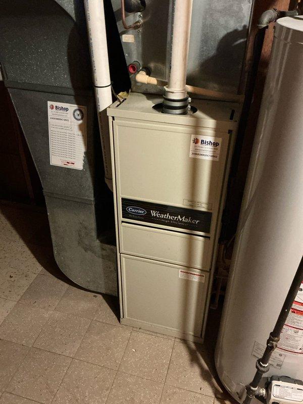 Conducted on-site assessment for central air conditioning unit replacement estimate. Documented existing Carrier WeatherMaker furnace installation with associated PVC venting, copper refrigerant lines, and ductwork configuration in basement mechanical room to determine compatibility requirements and installation scope for new AC system.