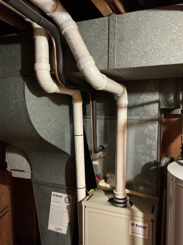 Conducted on-site assessment for central air conditioning unit replacement estimate. Documented existing Carrier WeatherMaker furnace installation with associated PVC venting, copper refrigerant lines, and ductwork configuration in basement mechanical room to determine compatibility requirements and installation scope for new AC system.