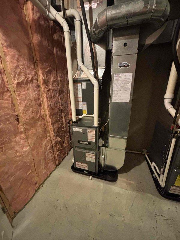 Completed full furnace installation in basement mechanical room. Installed new high-efficiency furnace unit with proper venting configuration using PVC intake and exhaust piping. Positioned equipment on condensate drain pan for moisture management. Connected all necessary ductwork to existing HVAC distribution system. Routed and secured all venting pipes according to manufacturer specifications and code requirements. Verified proper clearances from combustible materials and insulated walls. Completed all electrical connections and tested system operation to ensure proper functionality.