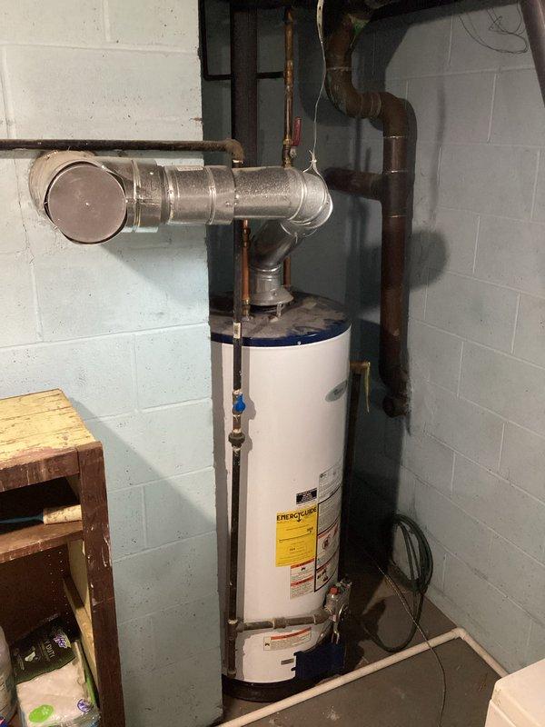 Conducted on-site evaluation of existing water heater installation in basement utility area and provided comprehensive estimate for replacement. Documented current system configuration including water heater unit, copper supply lines, galvanized venting components, shut-off valves, and electrical connections to determine replacement specifications and scope of work required.