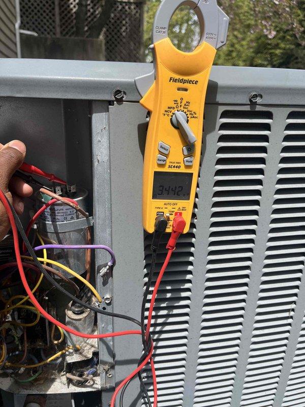 Completed annual cooling maintenance on 10+ year old Amana air conditioning system. Performed comprehensive system inspection including electrical testing with clamp meter, recording compressor amperage at 34.42 amps. Accessed control board and verified all electrical connections, wiring harnesses, and safety circuits. Inspected capacitor and contactor operation. Cleaned debris accumulation from unit base and surrounding area. All components tested within normal operating parameters and system returned to service in proper working condition.