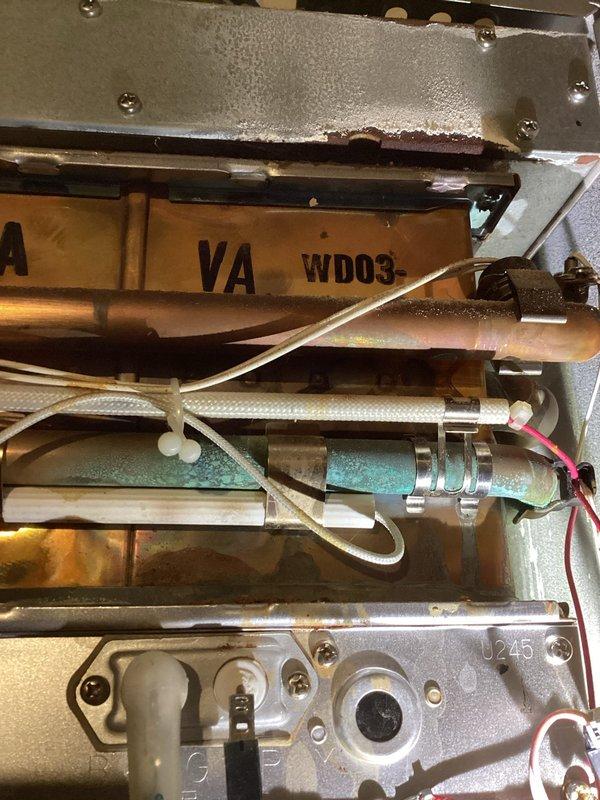 Responded to service call regarding gas odor detected from 12-year-old Rinnai tankless water heater when washing machine was operated. Performed comprehensive inspection of unit with cover removed, examining internal components including copper heat exchanger coils, electronic control boards, wiring, and digital display. Inspected all gas connections including flexible gas line, copper water supply lines, brass shut-off valves, and exhaust venting system for leaks or deterioration. Checked internal valve assemblies, braided water lines, and pressure components for proper operation and signs of wear. Documented unit condition with detailed photography showing internal mechanical components and overall installation. Recommended system flush due to age and maintenance history to address potential sediment buildup that may be contributing to operational issues.