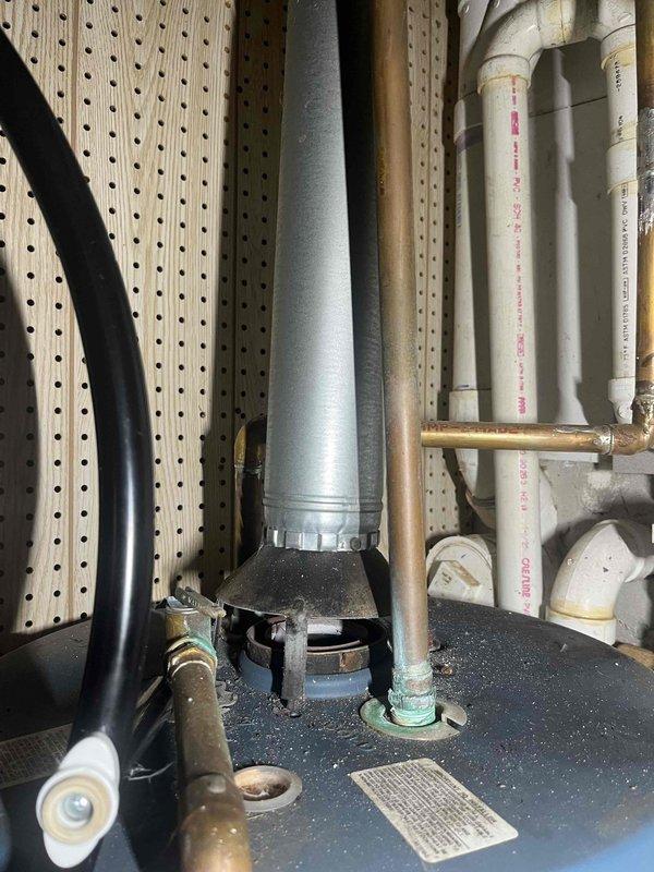 Responded to urgent safety concern regarding gas water heater with improper venting system causing carbon monoxide infiltration into basement area. Gas utility company identified that sidewall vent configuration was incorrectly installed, allowing combustion gases to re-enter living space rather than properly exhausting to exterior, resulting in elevated carbon monoxide levels during water heater operation. Conducted comprehensive assessment of existing water heater installation, photographed current venting configuration and equipment condition, and provided detailed estimate for complete water heater replacement with code-compliant vertical venting system to eliminate dangerous carbon monoxide hazard and ensure safe operation.