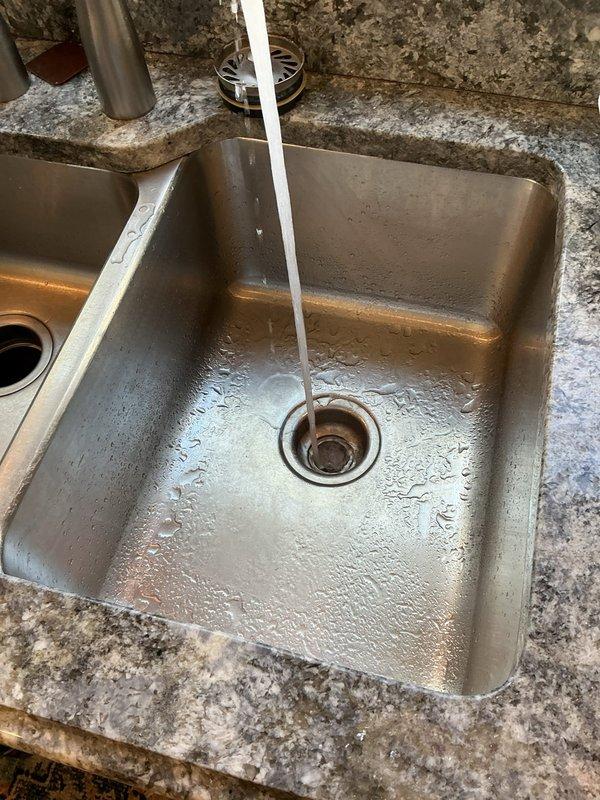 Returned to property with drain machine to clear kitchen sink clog as quoted. Successfully cleared obstruction from kitchen drain line using mechanical cable auger. Tested drainage system with running water to verify proper flow and confirm complete clearance of blockage.
