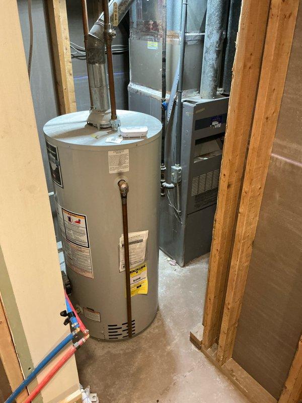Conducted comprehensive estimate for replacement of original 1991 ICP furnace and undersized air conditioning system in residential property. Upon inspection of existing equipment in basement utility area, confirmed furnace has reached end of serviceable life at 33 years old and requires replacement to prevent imminent failure. Evaluated current HVAC infrastructure including ductwork configuration, existing water heater placement, and available space for new equipment installation. Documented undersized AC unit inadequate for proper cooling capacity and recommended appropriately sized replacement system. Photographed existing mechanical room layout, furnace cabinet with specifications, connected ductwork, and surrounding utility connections to facilitate accurate equipment sizing and installation planning for complete furnace and air conditioning system replacement.