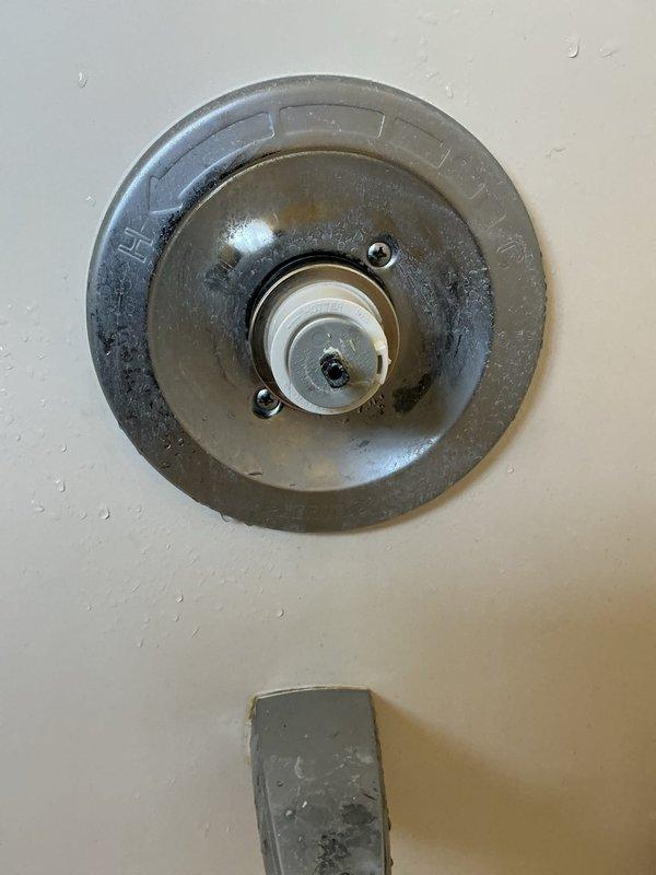 Responded to plumbing leak in ceiling. Upon investigation, accessed ceiling cavity and identified source of water intrusion at shower valve assembly above affected area. Inspected shower control valve and tub spout fixtures, noting moisture presence and potential seal failure at valve body connection. Disassembled valve trim and examined mounting components, discovering compromised gasket allowing water to bypass fixture and penetrate ceiling below. Replaced defective valve seals and gaskets, reassembled fixture, and tested system under full water pressure to verify repair integrity. Documented conditions with photographs for record. No further leakage detected upon completion of testing.