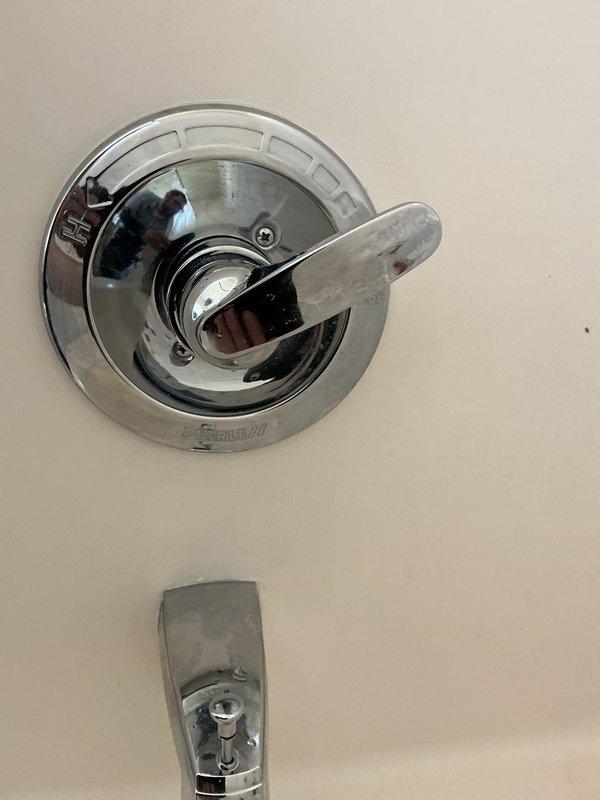 Responded to plumbing leak in ceiling. Upon investigation, accessed ceiling cavity and identified source of water intrusion at shower valve assembly above affected area. Inspected shower control valve and tub spout fixtures, noting moisture presence and potential seal failure at valve body connection. Disassembled valve trim and examined mounting components, discovering compromised gasket allowing water to bypass fixture and penetrate ceiling below. Replaced defective valve seals and gaskets, reassembled fixture, and tested system under full water pressure to verify repair integrity. Documented conditions with photographs for record. No further leakage detected upon completion of testing.