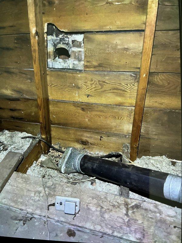 # No Heat Service Call

Responded to a no heat complaint on a 70-year-old furnace system. Upon arrival, conducted a comprehensive system inspection to diagnose the heating failure. Investigation revealed significant issues with the existing ductwork and venting system in the attic/crawl space area.

Found deteriorated and improperly configured ductwork, including damaged flexible duct sections and compromised PVC venting components. The metal vent opening showed signs of age-related deterioration with visible residue buildup affecting proper airflow. The existing duct connections were loose and separated, preventing adequate heated air distribution throughout the home.

The combustion venting system displayed concerning conditions, with the PVC exhaust pipe showing dust accumulation and potential air leakage at connection points. The metal coupling at the transition joint required attention due to improper sealing. Wooden structural components surrounding the vent penetrations showed m