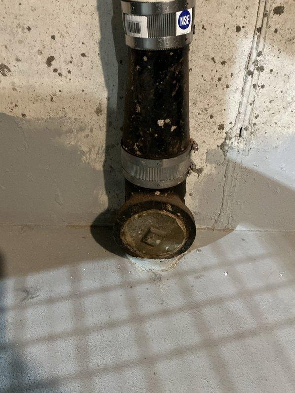 Responded to main line sewer backup in basement area. Upon arrival, located cleanout access point at base of vertical PVC drain stack secured to concrete block wall. Deployed mechanical cable snake through cleanout to clear obstruction in main sewer line. Successfully removed blockage and restored proper drainage flow. Tested system to verify complete clearance and proper operation of drain system.