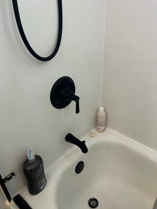 Successfully installed customer-supplied matte black kitchen faucet with dual handles and matching tub spout in bathroom to coordinate with existing design aesthetic. All fixtures were properly mounted, connected to existing water supply lines, tested for leaks, and confirmed fully operational with proper water flow and drainage.