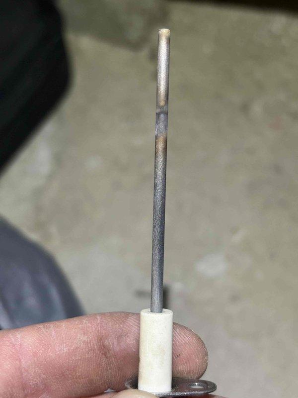 Responded to no heat call on 24-year-old Frigidaire furnace with intermittent heating issues. Upon inspection, found failed flame sensor with significant carbon buildup and oxidation preventing proper flame detection, causing furnace to cycle between heating mode and fan-only operation. Removed and replaced flame sensor with new OEM part, verified proper flame signal, and tested multiple heating cycles to confirm consistent operation and reliable ignition.