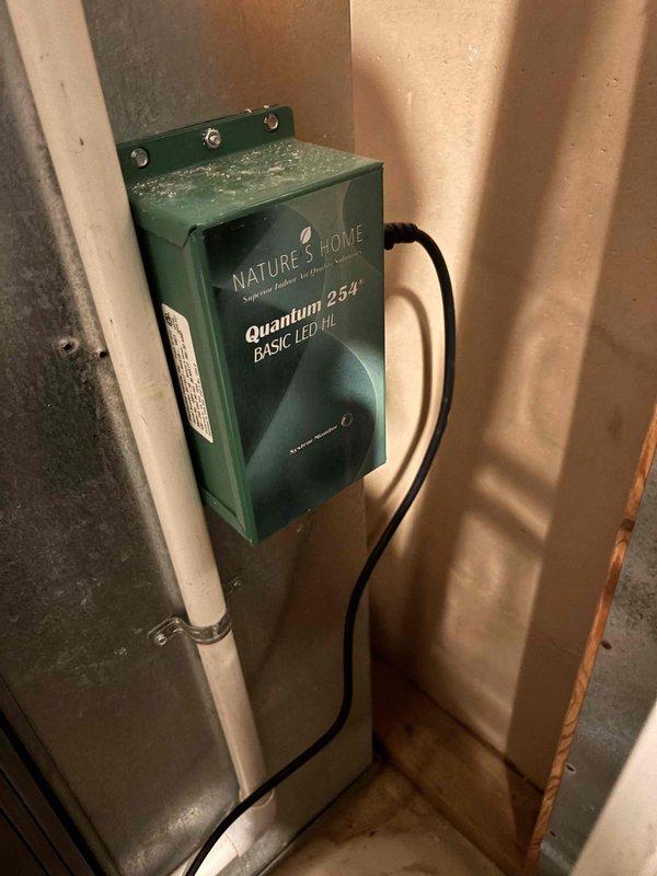 Completed annual cooling maintenance on a 7-year-old EcoAir system with a 2019 condenser model. Inspected the Nature's Home Quantum 25A BASIC LED III control box mounted in the utility area, verified proper electrical connections and power supply functionality. Examined interior ductwork components, noting normal operational dust accumulation on metal surfaces and confirmed damper mechanism rods were intact and functioning properly.