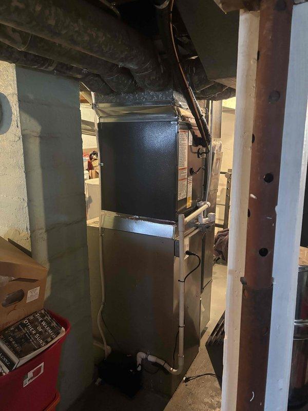 Successfully completed add-on air conditioning installation to existing forced-air heating system in residential basement. Integrated new AC evaporator coil with existing furnace unit, establishing proper refrigerant connections and electrical interfaces. Installed outdoor condensing unit with A2L refrigerant system containing factory charge of 54.6 ounces with no additional field charge required. Verified all refrigerant line connections, service valves, and brass fittings for proper sealing and operation. Completed all ductwork modifications to accommodate new cooling system components. System tested and confirmed operational with proper airflow and temperature differential across evaporator coil.