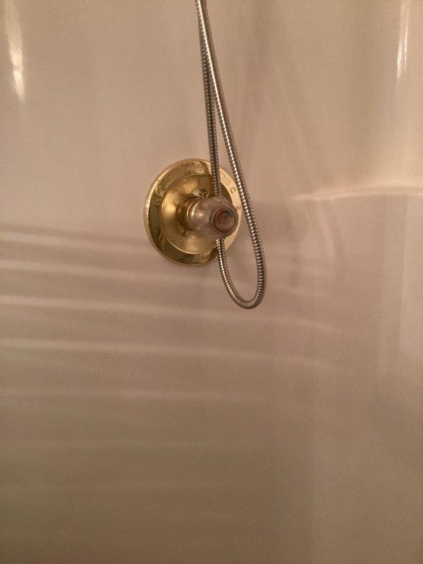 Responded to service call for leaking shower faucet in approximately 30-year-old home where slow leak had been worsening over time. Upon inspection, identified worn internal valve components within the brass shower control valve as the source of the leak. Disassembled the shower valve assembly by removing the decorative acrylic handle and escutcheon plate to access the valve cartridge. Replaced deteriorated cartridge seals and O-rings that had failed due to age and mineral buildup. Reassembled the fixture, ensuring proper alignment and secure mounting of all components. Tested the valve operation through multiple cycles to verify complete leak elimination and smooth handle operation. Confirmed no additional leaks present at second shower location after thorough inspection. System restored to proper working condition with no further dripping or water loss.