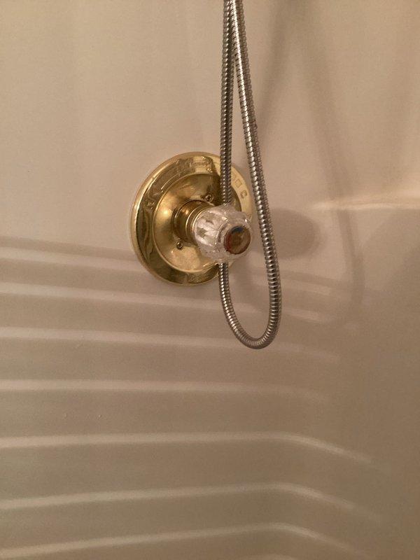 Responded to service call for leaking shower faucet in approximately 30-year-old home where slow leak had been worsening over time. Upon inspection, identified worn internal valve components within the brass shower control valve as the source of the leak. Disassembled the shower valve assembly by removing the decorative acrylic handle and escutcheon plate to access the valve cartridge. Replaced deteriorated cartridge seals and O-rings that had failed due to age and mineral buildup. Reassembled the fixture, ensuring proper alignment and secure mounting of all components. Tested the valve operation through multiple cycles to verify complete leak elimination and smooth handle operation. Confirmed no additional leaks present at second shower location after thorough inspection. System restored to proper working condition with no further dripping or water loss.