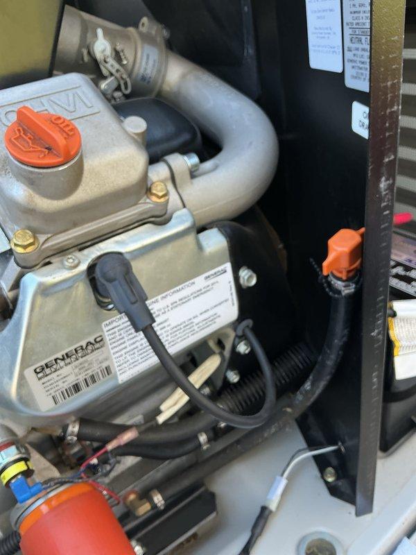 Completed annual preventative maintenance and tune-up on 11-year-old Generac generator unit. Performed comprehensive inspection of engine compartment, verified all internal components, checked fuel system including fuel cap and tank, inspected electrical connections and wiring harnesses, examined cooling system and exhaust assembly with clamps, and reviewed all safety labels and specifications. All components found in good operational condition with normal wear patterns. Unit photographed for service documentation.