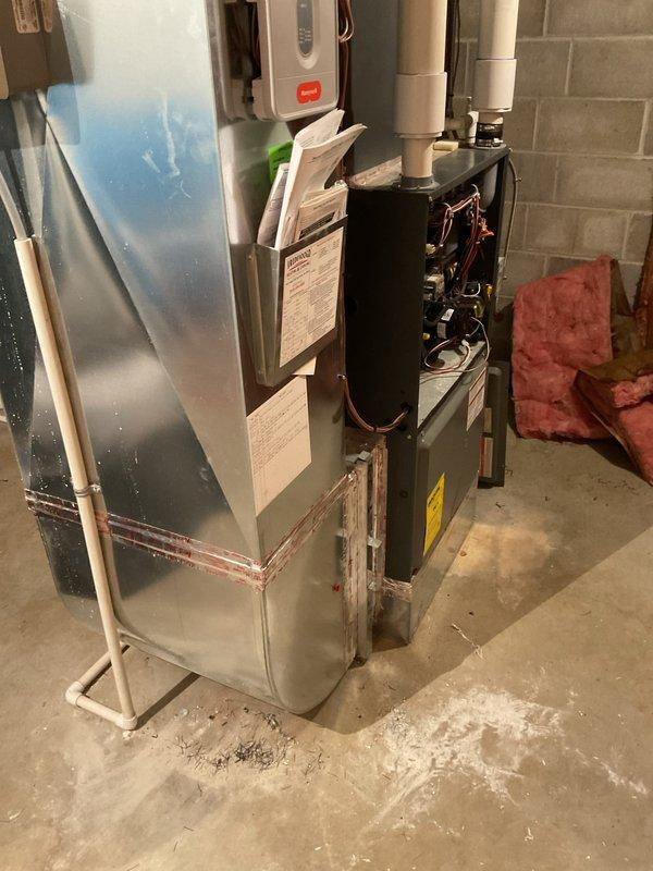 Responded to no heat call on 12-year-old EnergiAir furnace system. Upon arrival, confirmed unit was not operational. Inspection revealed worn heat exchangers presenting safety concerns, requiring system shutdown per manufacturer and safety guidelines. Identified frost accumulation on refrigerant lines indicating potential issues with cooling system components. Documented equipment condition with photos showing basement HVAC installation, worn furnace components, and icing on copper refrigeration lines. Advised customer of heat exchanger failure and safety implications. Due to compromised heat exchanger condition, unit could not be safely restored to operation. Discussed replacement options and system age considerations given 2013 installation date.