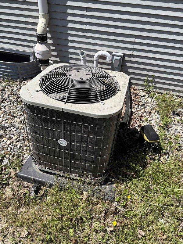 # ASTU-AC Super Tune-Up Completed

Performed comprehensive AC super tune-up on outdoor condenser unit with beige top cover and black wire mesh coil guards. Inspected severely deteriorated drain pan showing extensive corrosion with multiple holes and structural compromise requiring immediate replacement recommendation. Completed full system evaluation including condenser coils, fan operation, refrigerant levels, electrical connections, and condensate drainage system with U-bend PVC configuration.