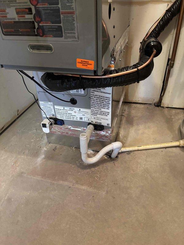 Completed full HVAC system replacement including outdoor condensing unit and indoor furnace. Installed new cylindrical condenser on existing concrete pad with proper clearances from gas meter and building structure. Ran refrigerant lines with appropriate insulation from outdoor unit through wall penetration to indoor air handler. Installed furnace in utility area with copper refrigerant lines, PVC condensate drainage system, and proper electrical connections. Verified all connections, tested system operation, and confirmed proper drainage flow.