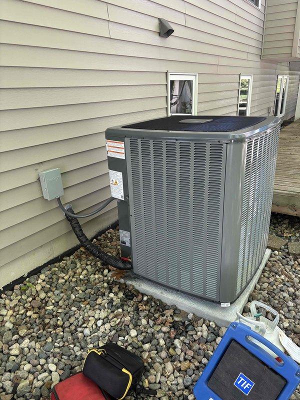 Completed full air conditioning system replacement at residential property. Installed new outdoor condensing unit on existing concrete pad with proper clearances, connected refrigerant lines with appropriate field charge added to factory charge for total system capacity, and verified all electrical connections including disconnect box and conduit routing. System tested and operational upon completion.