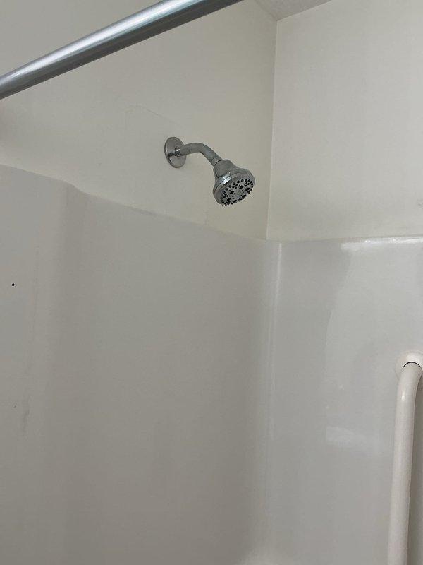 Completed shower valve replacement in residential bathroom. Removed existing worn valve assembly and installed new chrome-finished shower control valve with multi-function showerhead. Verified proper water flow, temperature control, and eliminated previous leaking issue. All fixtures tested and operational upon completion.