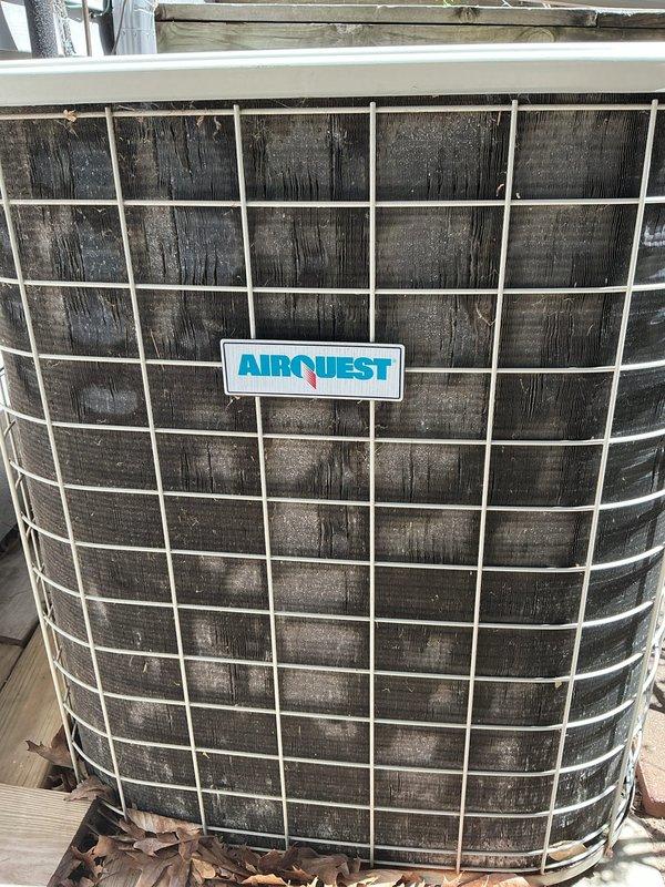 Completed ASTU-AC Super Tune-up on 16-year-old AirQuest outdoor condensing unit. Performed comprehensive system inspection, straightened bent condenser fins to restore proper airflow, and cleaned heavily soiled coil surfaces which showed significant dirt and debris accumulation. Verified unit operational performance and provided consultation regarding mini-split installation options for garage heating application.