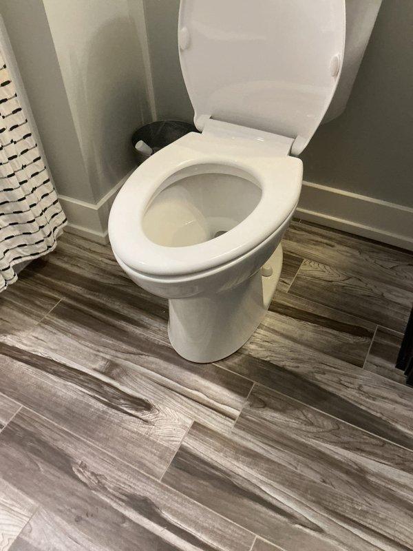 Responded to report of toilet leaking at base with water penetrating through floor to level below. Upon inspection, identified compromised wax ring seal between toilet base and closet flange. Removed toilet, scraped old wax ring, inspected flange for damage, and installed new wax ring seal. Reset toilet with proper alignment, tightened closet bolts to manufacturer specifications, and tested for leaks. Verified water-tight seal at base and confirmed no further leakage to lower floor.