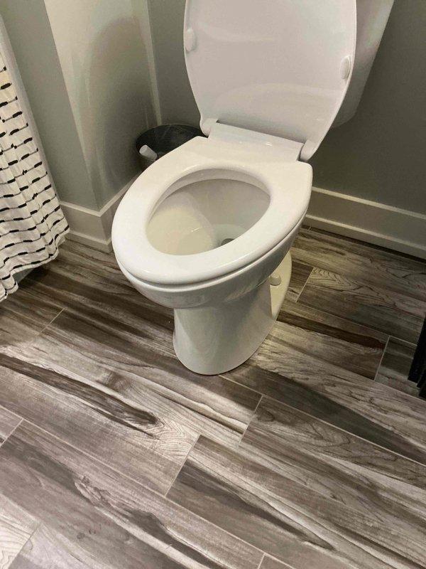 Responded to report of toilet leaking at base with water penetrating through floor to level below. Upon inspection, identified compromised wax ring seal between toilet base and closet flange. Removed toilet, scraped old wax ring, inspected flange for damage, and installed new wax ring seal. Reset toilet with proper alignment, tightened closet bolts to manufacturer specifications, and tested for leaks. Verified water-tight seal at base and confirmed no further leakage to lower floor.
