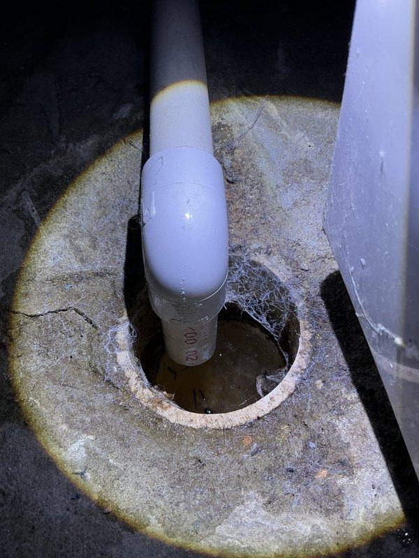Completed annual cooling maintenance on 2017 EnergiAir system under active warranty coverage. Performed comprehensive tune-up including system inspection, refrigerant level verification, electrical component testing, and condensate drain evaluation. Photos documented PVC condensate drain line condition showing mineral deposits and staining around pipe penetration, indicating proper drainage function with evidence of normal moisture evacuation over time.