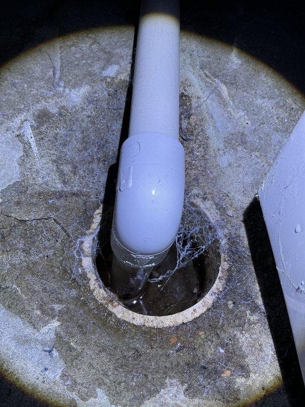 Completed annual cooling maintenance on 2017 EnergiAir system under active warranty coverage. Performed comprehensive tune-up including system inspection, refrigerant level verification, electrical component testing, and condensate drain evaluation. Photos documented PVC condensate drain line condition showing mineral deposits and staining around pipe penetration, indicating proper drainage function with evidence of normal moisture evacuation over time.