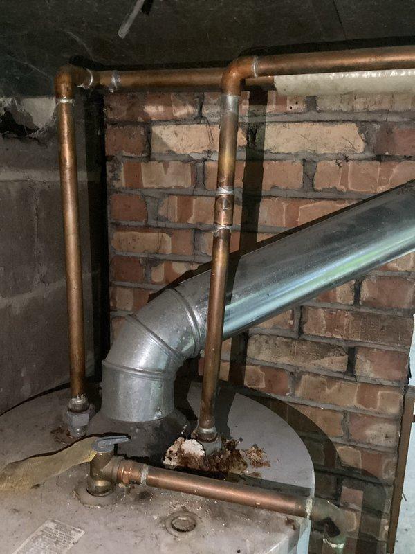 Provided estimate for replacement of 40-gallon natural gas water heater manufactured in May 2003 that is actively leaking from the base. Unit has exceeded its 6-year limited warranty period and shows significant age-related deterioration requiring full replacement rather than repair.