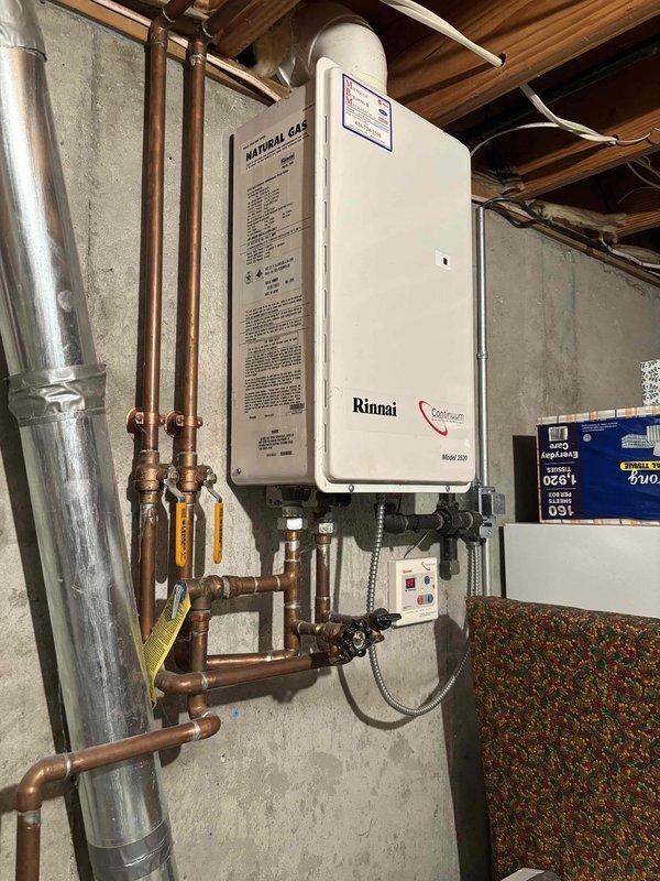 Responded to follow-up service call for persistent water softener leak that remained unresolved after previous plumbing visit. Upon arrival, inspected water softener system with digital control head displaying operational status, along with associated copper supply piping and connections in utility room adjacent to Rinnai tankless water heater installation. Identified source of leak, performed necessary repairs to water softener plumbing connections and fittings, and verified system integrity. Tested all connections under pressure to confirm leak was eliminated. Documented installation with photos showing water softener control unit, piping configuration, and surrounding mechanical systems for service records.