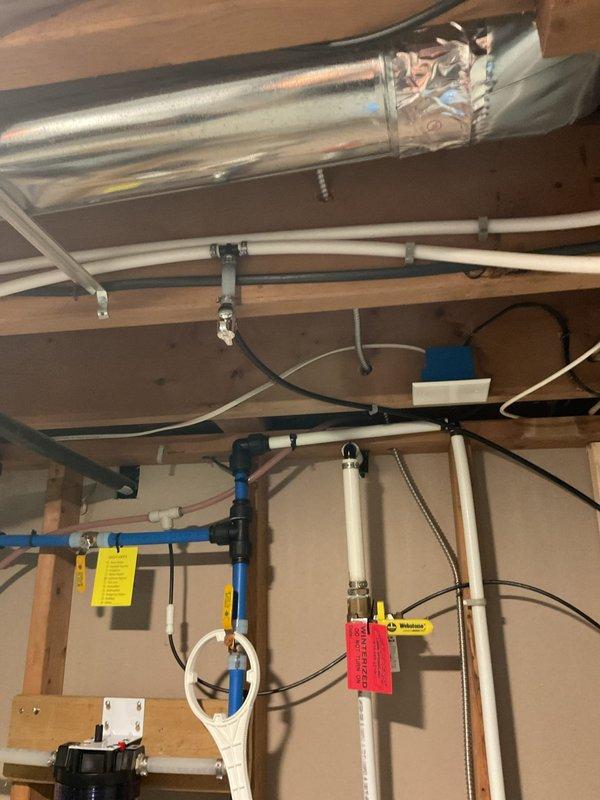 Responded to no-water issue at kitchen faucets following recent water service restoration. Accessed crawl space to inspect supply lines and verified proper water flow through main distribution system, including PEX and PVC supply lines. Restored full water pressure and functionality to kitchen sink faucets, including main gooseneck fixture and auxiliary filtration faucet, by addressing air lock in supply lines after municipal water turn-on.