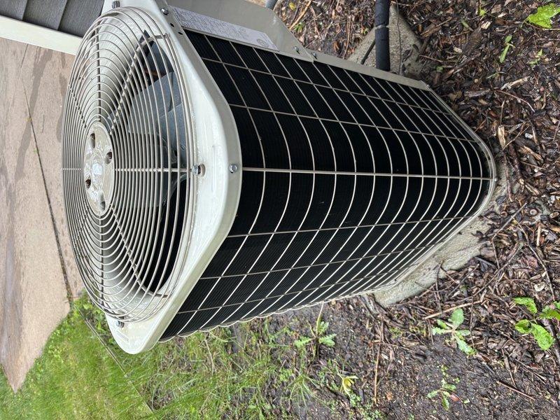 Completed annual cooling maintenance on 21-year-old Payne air conditioning system. Performed comprehensive tune-up including inspection of condenser unit, verified fan operation and protective grille integrity, assessed heat exchanger coil condition, and documented equipment status with photographic records. Unit found in operational condition with coils clean and free of debris; no immediate repairs required at time of service.