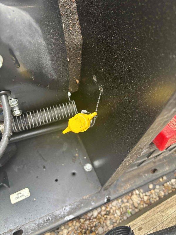 Responded to service call for 20-year-old Generac generator that failed to start during recent power outage and was not executing weekly self-test cycles. Upon arrival, performed comprehensive diagnostic evaluation of unit housed in ventilated wooden enclosure. Inspected engine compartment, checking fluid levels including oil reservoir identified by yellow dipstick cap. Examined air intake system with corrugated rubber hose and clamp connections for proper sealing and debris obstruction. Verified battery connections and charging system functionality. Tested control board operations and self-test programming parameters. Cleaned accumulated dirt, dust, and debris from engine bay and critical components affecting proper ventilation and operation. Documented equipment condition through photographic records showing engine compartment details and overall unit configuration with protective metal hood and warning labels. Restored generator to operational status with confirmed successful start 