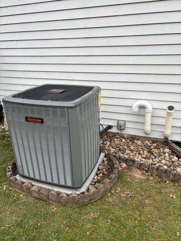 Completed full HVAC system installation including new furnace and air conditioning condenser unit. Installed outdoor AC unit on prepared concrete pad with proper clearances from building structure, established secure mounting, and connected refrigerant lines and electrical service. Positioned unit adjacent to exterior wall with appropriate drainage considerations and landscaping rock border for water management. Verified proper operation of both heating and cooling systems, confirmed electrical connections meet code requirements, and ensured all components functioning within manufacturer specifications.