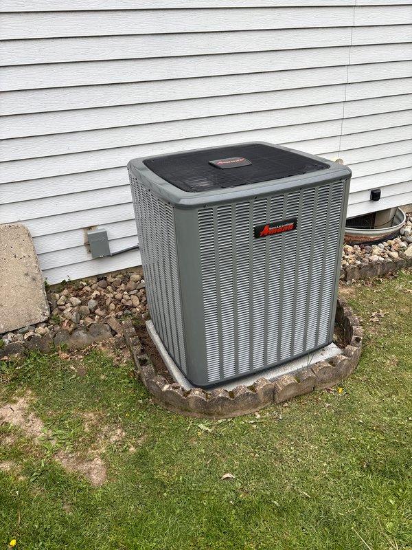 Completed full HVAC system installation including new furnace and air conditioning condenser unit. Installed outdoor AC unit on prepared concrete pad with proper clearances from building structure, established secure mounting, and connected refrigerant lines and electrical service. Positioned unit adjacent to exterior wall with appropriate drainage considerations and landscaping rock border for water management. Verified proper operation of both heating and cooling systems, confirmed electrical connections meet code requirements, and ensured all components functioning within manufacturer specifications.