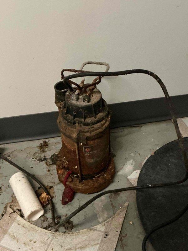 Completed sump pump replacement in basement utility area. Removed heavily corroded and deteriorated existing pump unit showing extensive rust damage and mineral buildup from prolonged moisture exposure. Installed new sump pump system with proper electrical connections and discharge piping. Cleared debris and sediment from surrounding work area and verified proper pump operation upon completion.